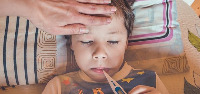 Boy with thermometer - Difference between Flu, RSV, and COVID