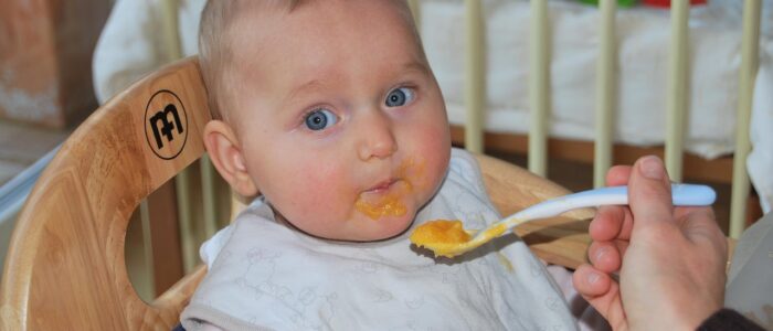 Baby being fed solid food - Starting solids post